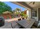 Outdoor patio features a dining table and backyard access with pool and lounging area at 834 W Whitten St, Chandler, AZ 85225