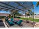 Backyard patio featuring a grill, seating, pergola, manicured lawn, and mature trees at 855 S Revolta Cir, Mesa, AZ 85208
