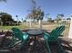 Backyard view showcasing a quaint seating area, rock landscaping, a white fence, and a manicured lawn at 855 S Revolta Cir, Mesa, AZ 85208