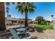 Backyard space with outdoor seating areas, including a patio, mature trees, and manicured lawn at 855 S Revolta Cir, Mesa, AZ 85208
