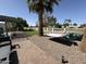Spacious backyard with a hammock, patio, rock landscaping, mature trees, and manicured lawn at 855 S Revolta Cir, Mesa, AZ 85208