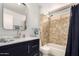Well-lit bathroom featuring a modern vanity, marble countertop, and a tiled shower/tub combination at 855 S Revolta Cir, Mesa, AZ 85208