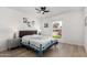 Bright bedroom with a ceiling fan, light hardwood floors, and a large window, creating a relaxing atmosphere at 855 S Revolta Cir, Mesa, AZ 85208