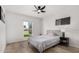 Bedroom with a comfy queen bed, a window, hardwood floor and ceiling fan at 855 S Revolta Cir, Mesa, AZ 85208