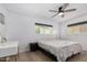 Bright bedroom with a desk, ceiling fan and hardwood floor at 855 S Revolta Cir, Mesa, AZ 85208