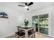 Cozy dining area with sliding glass doors leading to a patio, ceiling fan and white table at 855 S Revolta Cir, Mesa, AZ 85208