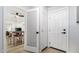 Hallway leading to living room featuring tile floors and fresh, white doors at 855 S Revolta Cir, Mesa, AZ 85208