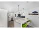Modern kitchen boasts white cabinetry, marble countertops, a stylish island, and stainless steel appliances at 855 S Revolta Cir, Mesa, AZ 85208