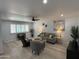 Bright living room featuring light wood floors, plantation shutters, and stylish, comfortable furniture at 855 S Revolta Cir, Mesa, AZ 85208