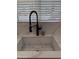 Close-up of the kitchen sink featuring a modern faucet and quartz countertops at 855 S Revolta Cir, Mesa, AZ 85208