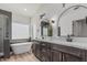 Elegant bathroom featuring dual sinks, marble countertops and a soaking tub at 862 W Rawhide Ave, Gilbert, AZ 85233