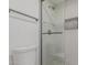 A modern bathroom featuring a toilet and glass door shower with tiled walls and recessed niche at 862 W Rawhide Ave, Gilbert, AZ 85233