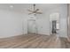 Bright bedroom featuring wood floors, ceiling fan and an arched entryway to an ensuite bathroom at 862 W Rawhide Ave, Gilbert, AZ 85233