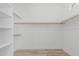 Spacious walk-in closet with built-in shelving and wood flooring at 862 W Rawhide Ave, Gilbert, AZ 85233