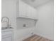 Well-lit laundry room with white cabinets, sink, and connections, ideal for laundry chores at 862 W Rawhide Ave, Gilbert, AZ 85233