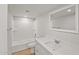 Bathroom featuring a shower-tub combo, wood look floors, and a modern vanity at 921 S Val Vista Dr # 135, Mesa, AZ 85204