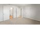 Bedroom with neutral carpet, adjacent bathroom, and ample closet space via multiple doors at 921 S Val Vista Dr # 135, Mesa, AZ 85204