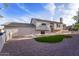 Exterior view of the home showing the gravel landscaping and small decorative front lawn at 921 S Val Vista Dr # 135, Mesa, AZ 85204
