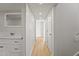 Bright hallway with wood floors, white doors, and recessed lighting at 921 S Val Vista Dr # 135, Mesa, AZ 85204