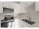 Close up of modern kitchen featuring stainless steel appliances and fixtures, and white cabinets at 921 S Val Vista Dr # 135, Mesa, AZ 85204