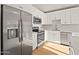 Modern kitchen features stainless steel appliances, quartz countertops, and sleek white cabinets at 921 S Val Vista Dr # 135, Mesa, AZ 85204