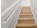 Bright staircase with wood stairs and white walls at 921 S Val Vista Dr # 135, Mesa, AZ 85204