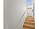 Bright staircase with wood stairs and white walls at 921 S Val Vista Dr # 135, Mesa, AZ 85204