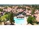 Aerial view of a community pool and spa surrounded by residential buildings with terracotta roofs at 1001 N Pasadena Dr # 105, Mesa, AZ 85201
