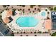 Overhead view of a community pool with lounge chairs, cabanas, and green landscaping at 1001 N Pasadena Dr # 105, Mesa, AZ 85201