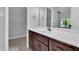 Bathroom featuring a white countertop, dark wood cabinets, and views of the closet and bedroom at 1001 N Pasadena Dr # 105, Mesa, AZ 85201