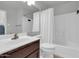 Full bathroom includes a vanity, toilet, and shower-tub combo with a white curtain at 1001 N Pasadena Dr # 105, Mesa, AZ 85201