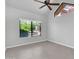 Bedroom showcasing a large window, ceiling fan, and neutral tile flooring at 1001 N Pasadena Dr # 105, Mesa, AZ 85201