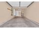 Clean, empty garage space with a sealed concrete floor, storage shelves, and an insulated door at 1001 N Pasadena Dr # 105, Mesa, AZ 85201