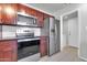 Updated kitchen featuring stainless steel appliances, modern cabinets, and tile flooring for easy maintenance at 1001 N Pasadena Dr # 105, Mesa, AZ 85201