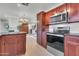 Well-appointed kitchen featuring stainless steel appliances, rich wood cabinetry, and a functional center island at 1001 N Pasadena Dr # 105, Mesa, AZ 85201