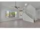 Inviting living room with tile floors, a staircase, and large windows offering natural light throughout the space at 1001 N Pasadena Dr # 105, Mesa, AZ 85201