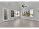 Bright living room featuring tile floors, a ceiling fan, and large windows offering plenty of natural light at 1001 N Pasadena Dr # 105, Mesa, AZ 85201