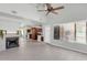 Spacious living room featuring a fireplace, tile flooring, and seamless flow into the modern kitchen area at 1001 N Pasadena Dr # 105, Mesa, AZ 85201