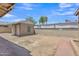 Backyard with partial dirt, block fence, storage shed and back of house at 101 W 8Th Pl, Mesa, AZ 85201