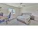 Comfortable bedroom with carpet, a ceiling fan, and a large window at 101 W 8Th Pl, Mesa, AZ 85201