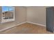 Bright, empty bedroom boasting hardwood floors, a closet, and a large window at 101 W 8Th Pl, Mesa, AZ 85201