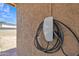 Tesla electric vehicle charger mounted on the textured exterior wall at 101 W 8Th Pl, Mesa, AZ 85201
