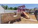 playset with slide and swings next to stone structure in backyard at 1017 S San Jose Cir, Mesa, AZ 85202