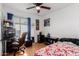 Bedroom with a window, a ceiling fan, a desk with decor, and a comfy bed at 1017 S San Jose Cir, Mesa, AZ 85202