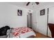 Bedroom with a ceiling fan, a door to the next room, and sports decorations at 1017 S San Jose Cir, Mesa, AZ 85202