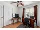 Bedroom with a ceiling fan, a sliding door to the backyard, and a desk with decor at 1017 S San Jose Cir, Mesa, AZ 85202