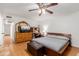 Spacious primary bedroom featuring hardwood floors, a ceiling fan and closet access at 1017 S San Jose Cir, Mesa, AZ 85202