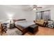 Bedroom with a ceiling fan, hardwood floors and a seating area at 1017 S San Jose Cir, Mesa, AZ 85202
