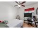 Cozy bedroom featuring a ceiling fan, window with blinds, and space for a desk, creating a functional space at 1017 S San Jose Cir, Mesa, AZ 85202