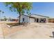 Charming single-story home with a well-manicured lawn, covered front porch, and attached two car garage at 1017 S San Jose Cir, Mesa, AZ 85202
